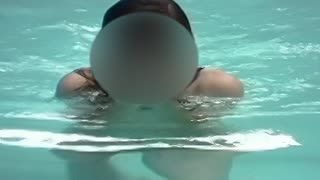  - On her back swimming nude